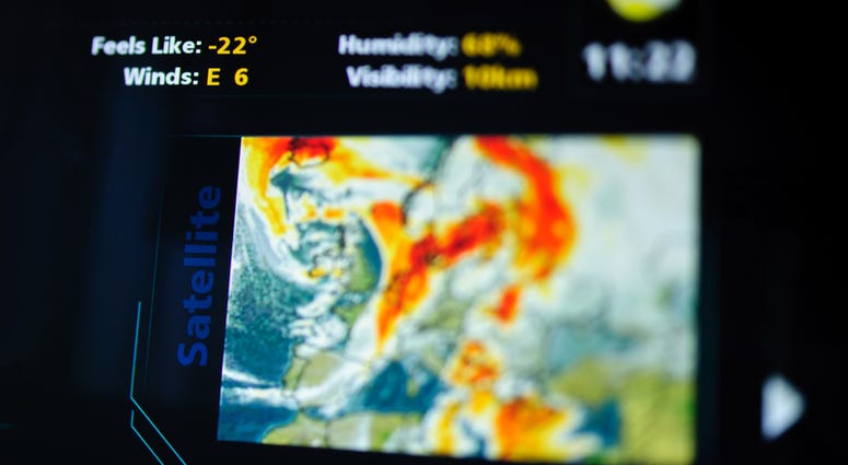 Digital weather forecast interface on a modern digital display showing cold weather for the next day eaturing an unrecognizable weather map. weather map