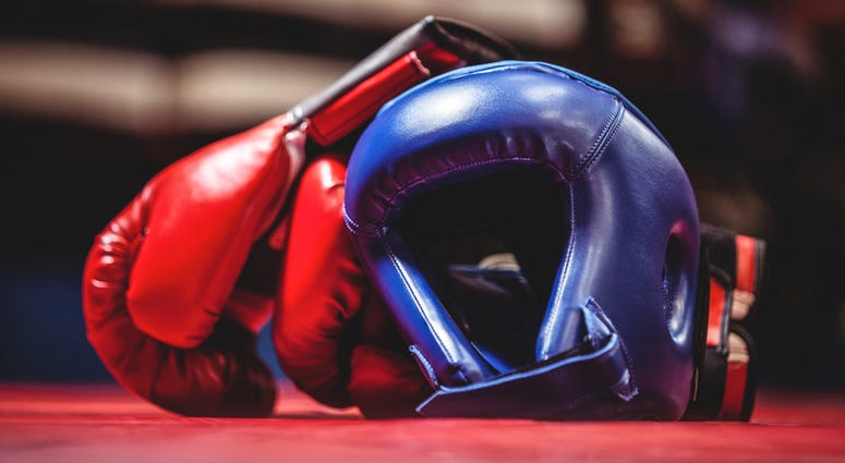 Pair of boxing gloves and headgear in boxing ring. Boxing Gloves