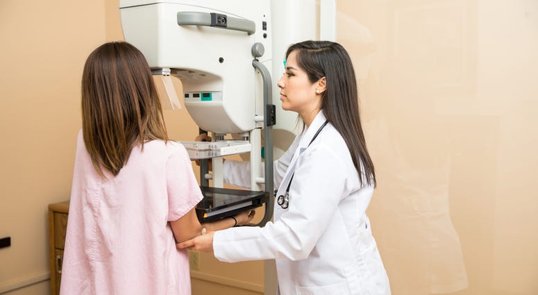 Doctor helps patient get a mammogram Doctor helps patient get a mammogram