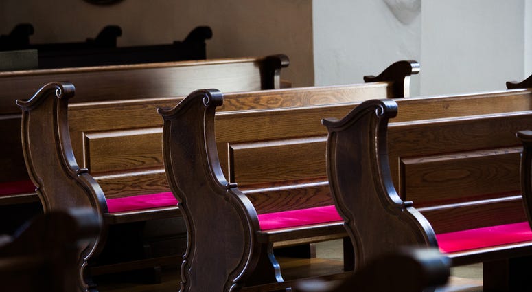 Empty wooden benches in old Catholic Church Empty wooden benches in old Catholic Church