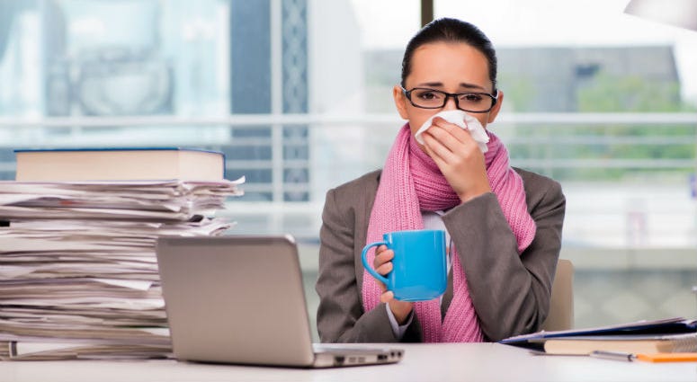 Young businesswoman sick in the office sick at work