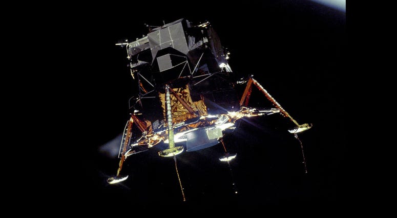 The Apollo 11 Lunar Module Eagle, in a landing configuration was photographed in lunar orbit from the Command and Service Module Columbia. The Apollo 11 Lunar Module Eagle, in a landing configuration was photographed in lunar orbit from the Command and Service Module Columbia.