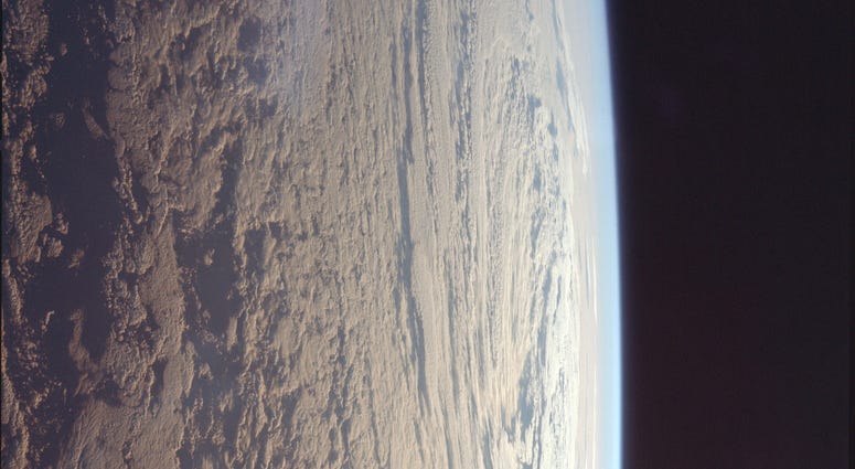 Astronaut Michael Collins took this photo of the cloud-speckled Earth, looking east towards the Sun. Astronaut Michael Collins took this photo of the cloud-speckled Earth, looking east towards the Sun.