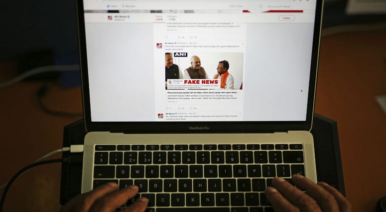 In this Tuesday, April 2, 2019, file photo, a man browses through the Twitter account of Alt News, a fact-checking website. In this Tuesday, April 2, 2019, file photo, a man browses through the Twitter account of Alt News, a fact-checking website.