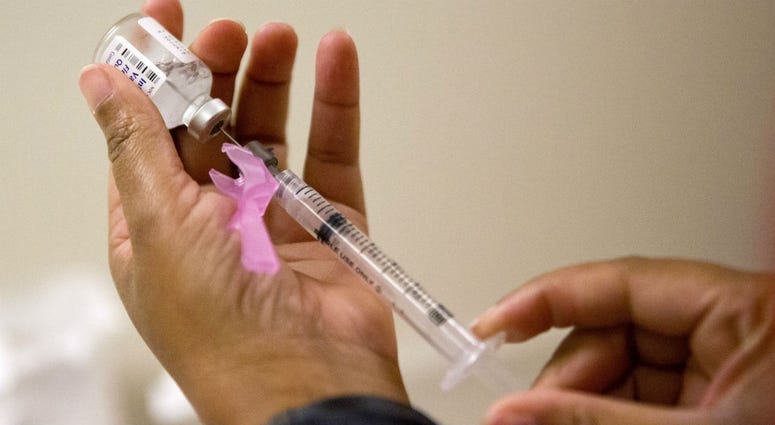 In this Wednesday, Feb. 7, 2018 file photo, a nurse prepares a flu shot in Atlanta. On Friday, June 8, 2018, health officials said the flu killed more children in the past year that during any other regular flu season in recent history. a nurse prepares a flu shot in Atlanta