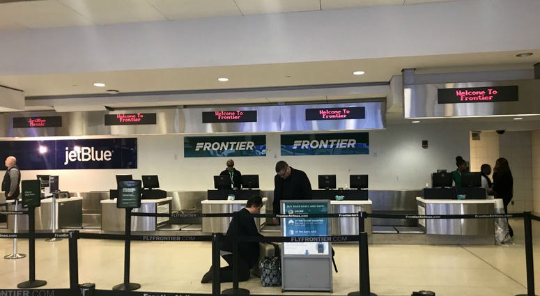 The Frontier Airlines check-in counter is shown at Philadelphia International Airport. The Frontier Airlines check-in counter is shown at Philadelphia International Airport.