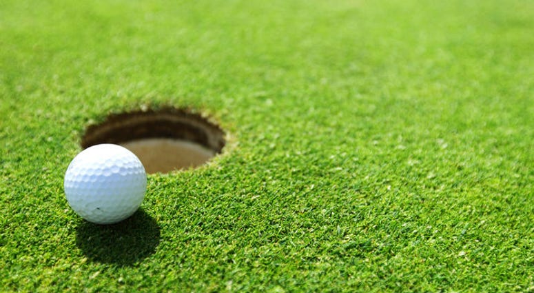 Golf ball on lip of cup Golf ball on lip of cup