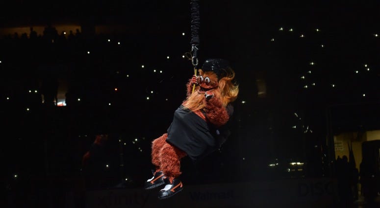 Philadelphia Flyers mascot Gritty is lowered from the rafters before the first period of a game between the Flyers and the New York Rangers at the Wells Fargo Center on Nov. 23, 2018. Gritty