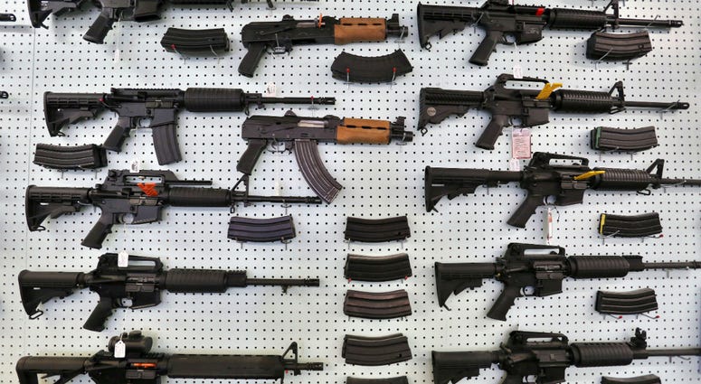 In this July 20, 2014 file photo, guns are displayed for sale by an arms seller east of Colorado Springs, Colo. In this July 20, 2014 file photo, guns are displayed for sale by an arms seller east of Colorado Springs, Colo.