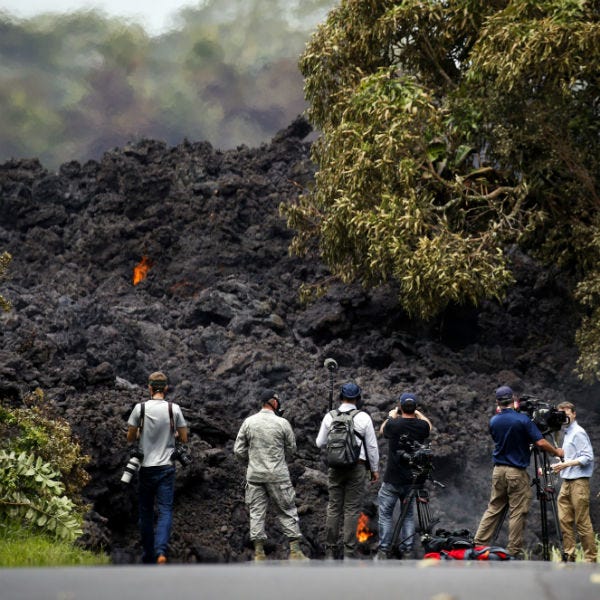 In this May 20, 2018 file photo, members of the media record a wall of lava entering the ocean near Pahoa, Hawaii. In this May 20, 2018 file photo, members of the media record a wall of lava entering the ocean near Pahoa, Hawaii.
