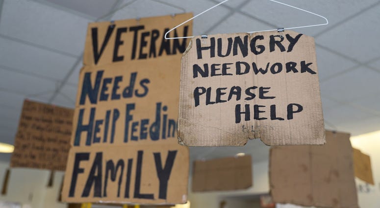 Willie Baronet, an artist and professor, purchased signs from the homeless people that they used to pander for money and turned them into a hanging art instillation. Willie Baronet, an artist and professor, purchased signs from the homeless people that they used to pander for money and turned them into a hanging art instillation.