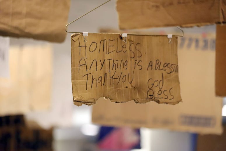Willie Baronet, an artist and professor, purchased signs from the homeless people that they used to pander for money and turned them into a hanging art instillation. Willie Baronet, an artist and professor, purchased signs from the homeless people that they used to pander for money and turned them into a hanging art instillation.