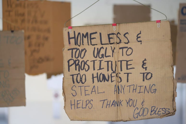 Willie Baronet, an artist and professor, purchased signs from the homeless people that they used to pander for money and turned them into a hanging art instillation. Willie Baronet, an artist and professor, purchased signs from the homeless people that they used to pander for money and turned them into a hanging art instillation.