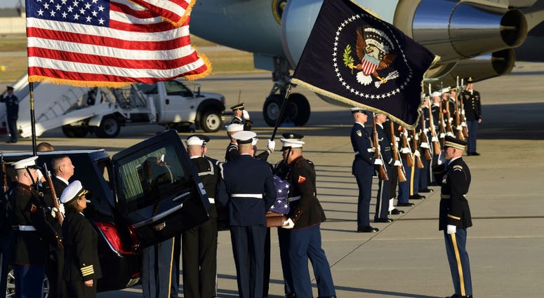 The flag-draped casket of former President George H.W. Bush is carried by a joint services military honor guard to a hearse at Andrews Air Force Base in Md., Monday, Dec. 3, 2018. The flag-draped casket of former President George H.W. Bush is carried by a joint services military honor guard to a hearse at Andrews Air Force Base in Md., Monday, Dec. 3, 2018.