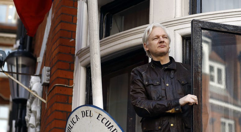 In this May 19, 2017 file photo, WikiLeaks founder Julian Assange gestures to supporters outside the Ecuadorian embassy in London, where he has been in self imposed exile since 2012. In this May 19, 2017 file photo, WikiLeaks founder Julian Assange gestures to supporters outside the Ecuadorian embassy in London, where he has been in self imposed exile since 2012.