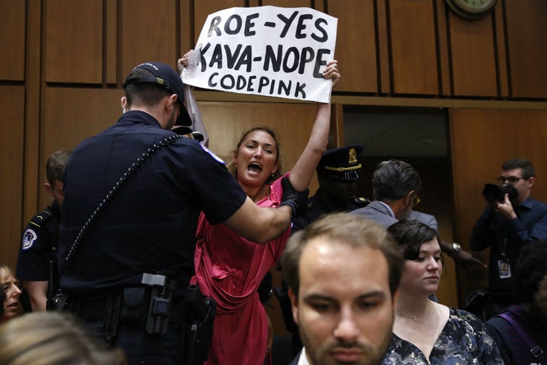 A woman stands and voices her opposition to Supreme Court nominee Brett Kavanaugh, during a Senate Judiciary Committee confirmation hearing on his nomination for Supreme Court, on Capitol Hill, Tuesday, Sept. 4, 2018, in Washington. A woman stands and voices her opposition to Supreme Court nominee Brett Kavanaugh, during a Senate Judiciary Committee confirmation hearing on his nomination for Supreme Court, on Capitol Hill, Tuesday, Sept. 4, 2018, in Washington.