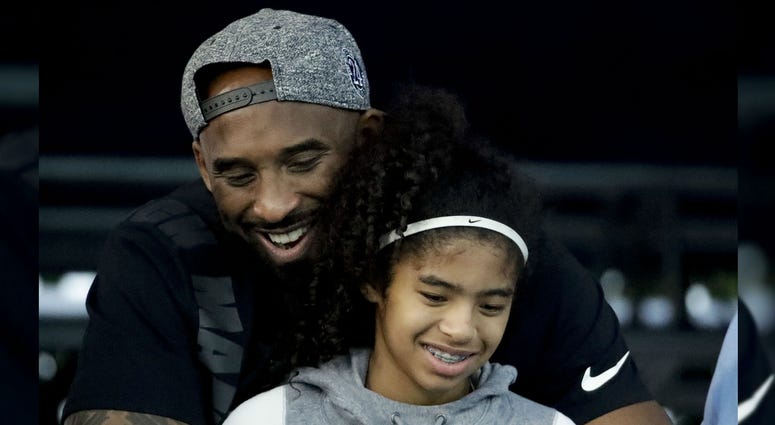 Former Los Angeles Laker Kobe Bryant and his daughter Gianna watch during the U.S. national championships swimming meet in Irvine, Calif., in 2018. Former Los Angeles Laker Kobe Bryant and his daughter Gianna watch during the U.S. national championships swimming meet in Irvine, Calif., in 2018.