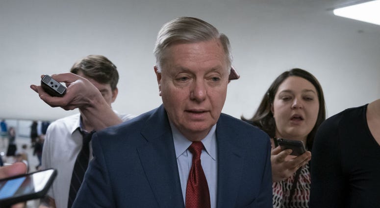 In this March 13, 2019, photo, reporters pose questions to Sen. Lindsey Graham, R-S.C., at the Capitol in Washington, Wednesday, March 13, 2019. In this March 13, 2019, photo, reporters pose questions to Sen. Lindsey Graham, R-S.C., at the Capitol in Washington, Wednesday, March 13, 2019.