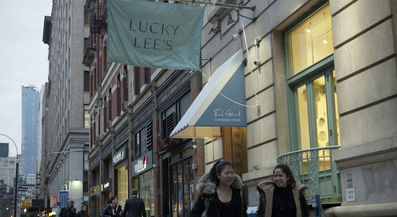 In this Thursday, April 11, 2019 photo, pedestrians walk past the Lucky Lee's restaurant in the Greenwich Village neighborhood of New York. In this Thursday, April 11, 2019 photo, pedestrians walk past the Lucky Lee's restaurant in the Greenwich Village neighborhood of New York.