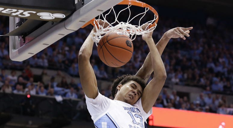 In this Dec. 15, 2018, file photo, North Carolina's Cameron Johnson (13) dunks against Gonzaga during the first half of an NCAA college basketball game, in Chapel Hill, N.C. In this Dec. 15, 2018, file photo, North Carolina's Cameron Johnson (13) dunks against Gonzaga during the first half of an NCAA college basketball game, in Chapel Hill, N.C.