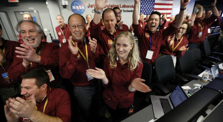Engineers celebrate as the InSight lander touch downs on Mars in the mission support area of the space flight operation facility at NASA's Jet Propulsion Laboratory Monday, Nov. 26, 2018, in Pasadena, Calif. Engineers celebrate as the InSight lander touch downs on Mars in the mission support area of the space flight operation facility at NASA's Jet Propulsion Laboratory Monday, Nov. 26, 2018, in Pasadena, Calif.