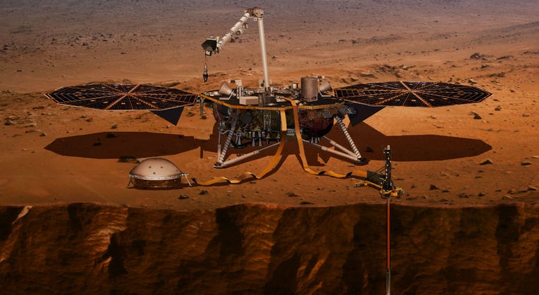 illustration made available by NASA in 2018 shows the InSight lander drilling into the surface of Mars. illustration made available by NASA in 2018 shows the InSight lander drilling into the surface of Mars.