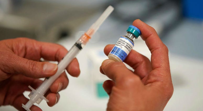 In this photo illustration a one dose bottle of measles, mumps and rubella virus vaccine In this photo illustration a one dose bottle of measles, mumps and rubella virus vaccine