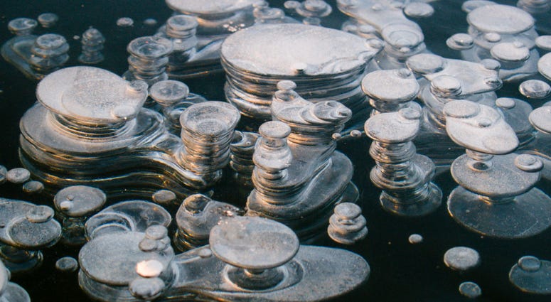 Methane bubble in the ice a of a freshly frozen Paezeriai lake in Lithuania Methane bubble in the ice a of a freshly frozen Paezeriai lake in Lithuania