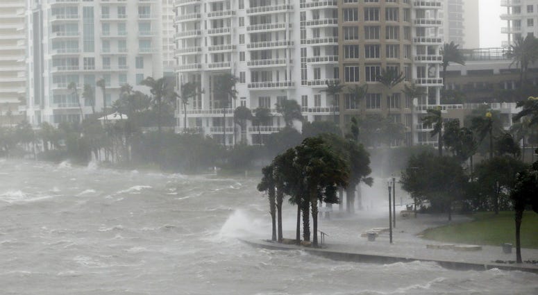This Sept. 10, 2017 file photo shows waves crashing over a seawall at the mouth of the Miami River from Biscayne Bay, Fla., as storm surge from Hurricane Irma impacts Miami. Hurricane Irma hits Miami