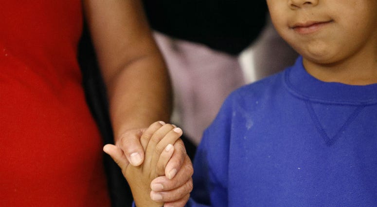 In this Friday, June 22, 2018, file photo, a mother, left, and son, from Guatemala, hold hands during a news conference following their reunion in Linthicum, Md., after being reunited following their separation at the U.S. border. In this Friday, June 22, 2018, file photo, a mother, left, and son, from Guatemala, hold hands during a news conference following their reunion in Linthicum, Md., after being reunited following their separation at the U.S. border.