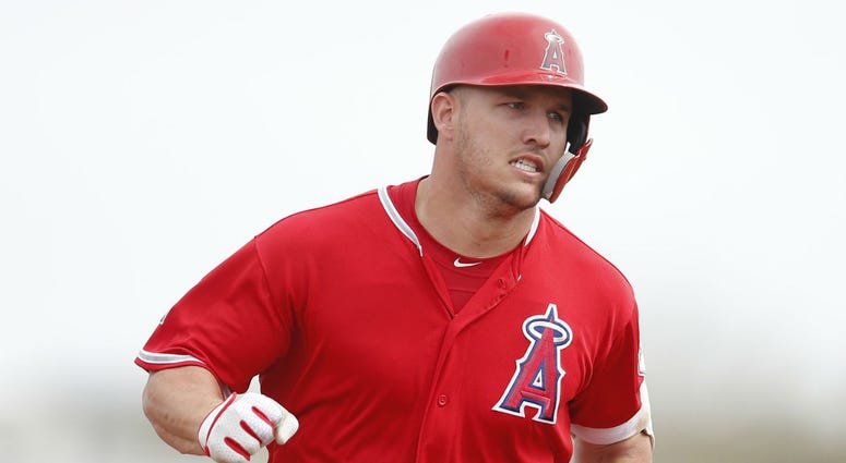 Los Angeles Angels center fielder Mike Trout (27) runs to third base after hitting a triple against the Los Angeles Dodgers in the first inning at Tempe Diablo Stadium. Los Angeles Angels center fielder Mike Trout (27) runs to third base after hitting a triple against the Los Angeles Dodgers in the first inning at Tempe Diablo Stadium.
