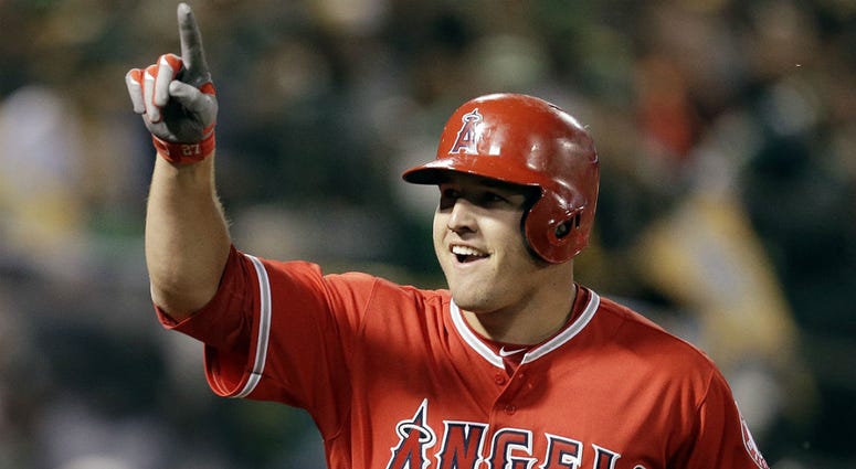 In this April 3, 2017, file photo, Los Angeles Angels' Mike Trout celebrates after hitting a two-run home run off Oakland Athletics' Kendall Graveman in the third inning of a baseball game in Oakland, Calif. In this April 3, 2017, file photo, Los Angeles Angels' Mike Trout celebrates after hitting a two-run home run off Oakland Athletics' Kendall Graveman in the third inning of a baseball game in Oakland, Calif.