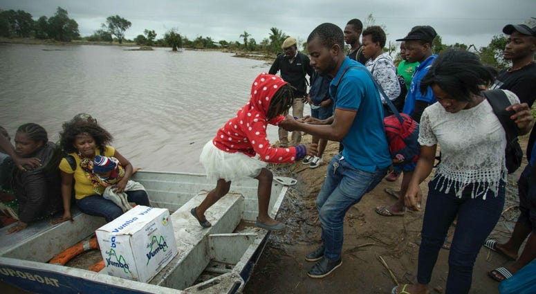 A young girl is helped from a boat after being evacuated from flood waters following cyclone force winds and heavy rain near the coastal city of Beira, Mozambique, Wednesday March 20, 2019. A young girl is helped from a boat after being evacuated from flood waters following cyclone force winds and heavy rain near the coastal city of Beira, Mozambique, Wednesday March 20, 2019.