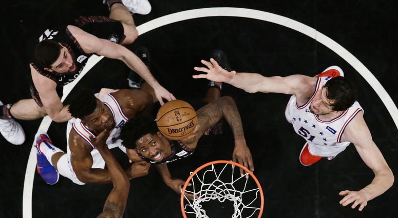 Philadelphia 76ers' Boban Marjanovic, right, shoots over Brooklyn Nets' Ed Davis, center, during the first half in Game 3 of a first-round NBA basketball playoff series Thursday, April 18, 2019, in New York. The 76ers won 131-115. Philadelphia 76ers' Boban Marjanovic, right, shoots over Brooklyn Nets' Ed Davis, center, during the first half in Game 3 of a first-round NBA basketball playoff series Thursday, April 18, 2019, in New York. The 76ers won 131-115.