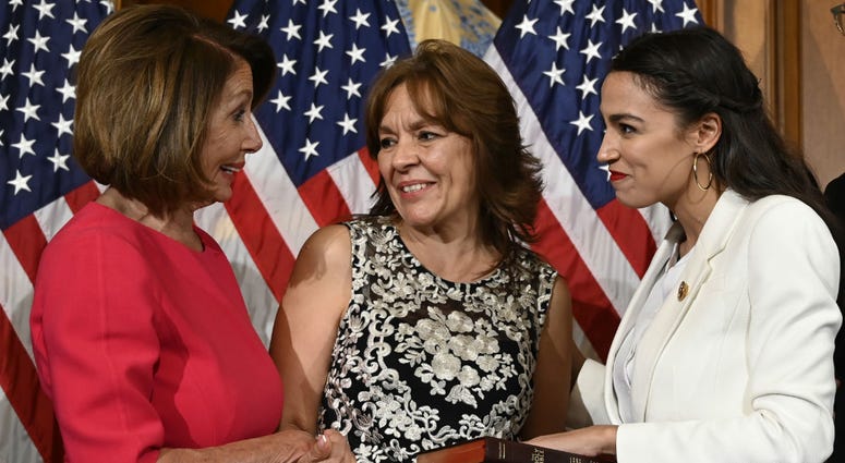House Speaker Nancy Pelosi of Calif., left, talks with Rep. Alexandria Ocasio-Cortez, D-N.Y., right, and her mother Blanca Ocasio-Cortez, center, during a ceremonial swearing-in. House Speaker Nancy Pelosi of Calif., left, talks with Rep. Alexandria Ocasio-Cortez, D-N.Y., right, and her mother Blanca Ocasio-Cortez, center, during a ceremonial swearing-in.