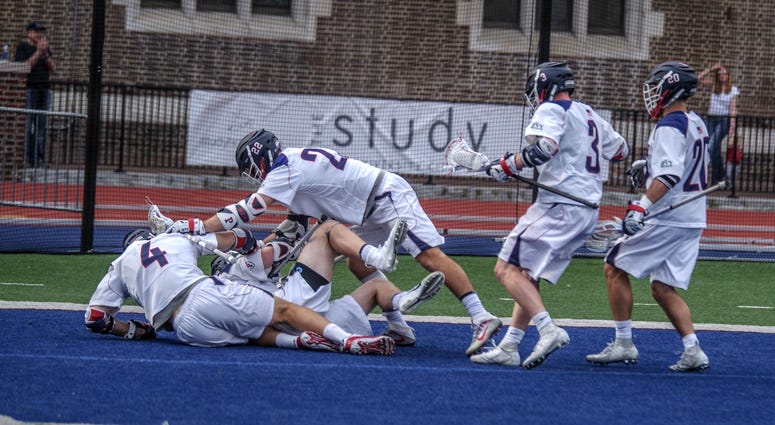 The University of Pennsylvania men's lacrosse team celebrates beating defending national champion Yale. The University of Pennsylvania men's lacrosse team celebrates beating defending national champion Yale.