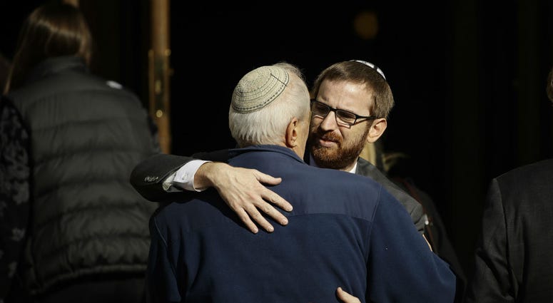 Mourners hug outside Rodef Shalom Congregation during the funeral services for brothers Cecil and David Rosenthal, Tuesday, Oct. 30, 2018, in Pittsburgh. Mourners hug outside Rodef Shalom Congregation during the funeral services for brothers Cecil and David Rosenthal, Tuesday, Oct. 30, 2018, in Pittsburgh.