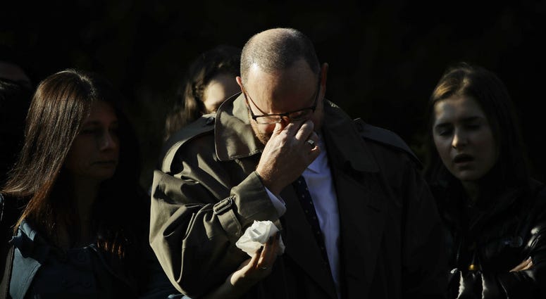A mourner reacts outside Rodef Shalom Congregation before the funeral services for brothers Cecil and David Rosenthal, Tuesday, Oct. 30, 2018, in Pittsburgh. A mourner reacts outside Rodef Shalom Congregation before the funeral services for brothers Cecil and David Rosenthal, Tuesday, Oct. 30, 2018, in Pittsburgh.