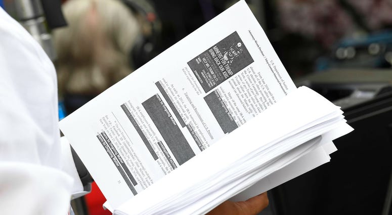 Television networks print out and read the released Mueller Report on the sidewalk outside of the Department of Justice. Television networks print out and read the released Mueller Report on the sidewalk outside of the Department of Justice.