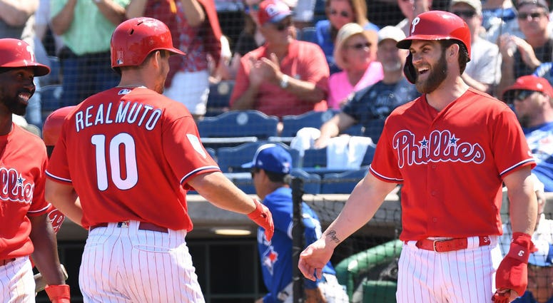 Philadelphia Phillies catcher J.T. Realmuto (10) is greeted by Philadelphia Phillies outfielder Bryce Harper (3) after hitting a home run in the fourth inning of the spring training game against the Toronto Blue Jays at Spectrum Field. Philadelphia Phillies catcher J.T. Realmuto (10) is greeted by Philadelphia Phillies outfielder Bryce Harper (3) after hitting a home run in the fourth inning of the spring training game against the Toronto Blue Jays at Spectrum Field.