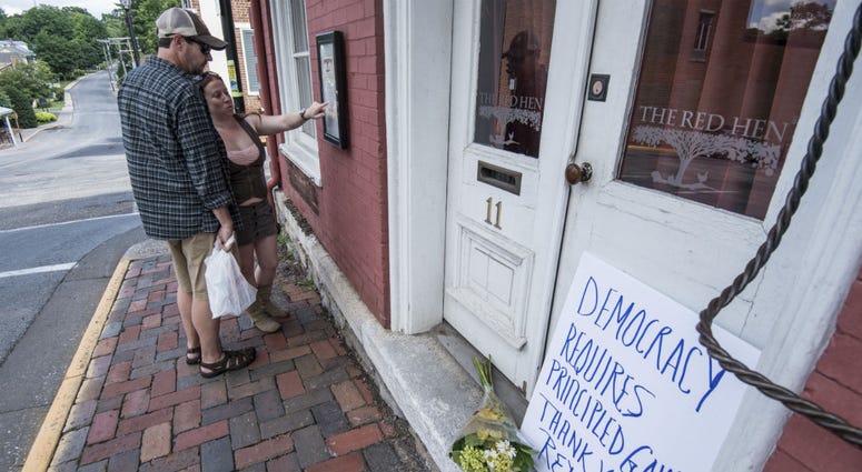 Passersby examine the menu at the Red Hen Restaurant Saturday, June 23, 2018, in Lexington, Va. Passersby examine the menu at the Red Hen Restaurant Saturday, June 23, 2018, in Lexington, Va.