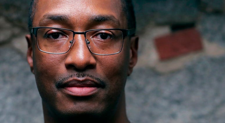 In this Tuesday June 4, 2019 photograph, Sean Ellis poses for a photo at the law office of his attorney Rosemary Scapicchio in Boston. Sean Ellis spent 22 years in prison after a wrongful conviction
