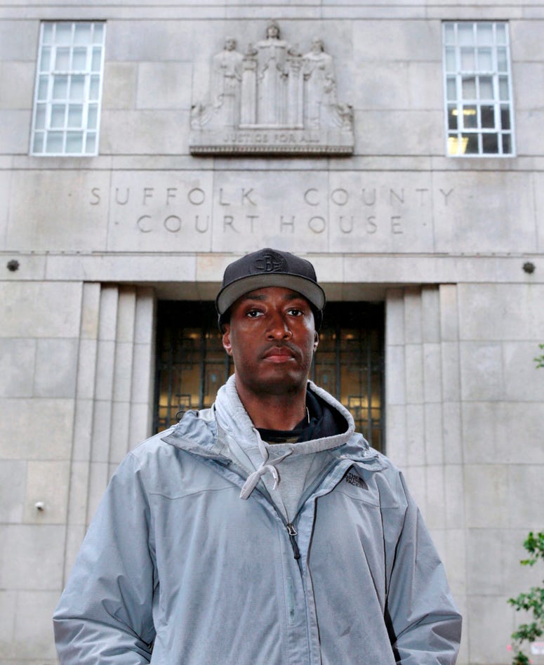 In this June 13, 2019 photo, Sean Ellis poses for a photo outside the Suffolk County Superior Court House in Boston. Sean Ellis spent 22 years in prison after a wrongful conviction