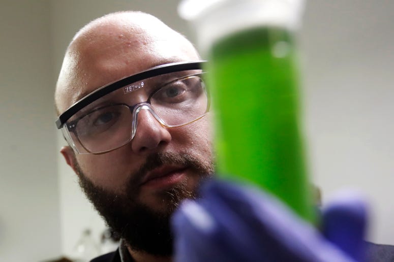 In this Friday, Aug. 16, 2019, photo, chemist David Dawson holds up a vial of extracted cannabis with an organic solvent as he demonstrates testing for THC and other chemicals at CW Analytical Laboratories in Oakland, Calif. In this Friday, Aug. 16, 2019, photo, chemist David Dawson holds up a vial of extracted cannabis with an organic solvent as he demonstrates testing for THC and other chemicals at CW Analytical Laboratories in Oakland, Calif.