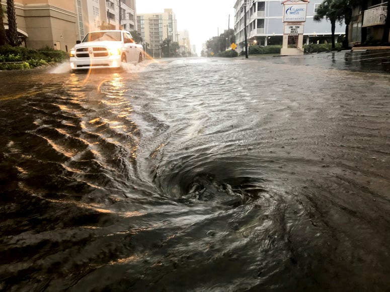 Floodwaters swirl around a storm drain as heavy rain falls from Hurricane Dorian, Thursday, Sept. 5, 2019, in North Myrtle Beach, S.C. Floodwaters swirl around a storm drain as heavy rain falls from Hurricane Dorian, Thursday, Sept. 5, 2019, in North Myrtle Beach, S.C.