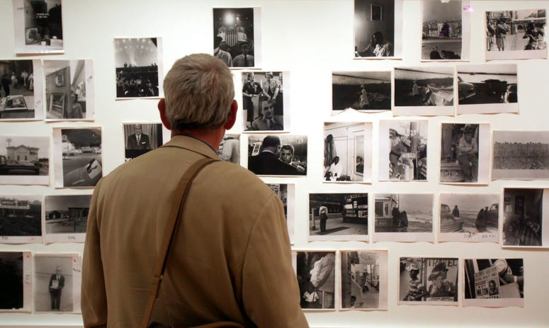 A man looks at prints from the Looking In: Robert Frank's "The Americans" exhibit at the Museum of Modern Art in San Francisco. A man looks at prints from the Looking In: Robert Frank's "The Americans" exhibit at the Museum of Modern Art in San Francisco.
