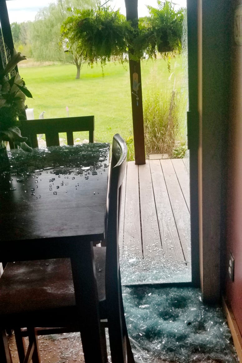 Broken glass from a sliding door is shown at a home in Sullivan Township, Ohio. Broken glass from a sliding door is shown at a home in Sullivan Township, Ohio.