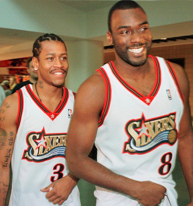 In this Oct. 4, 1999, file photo, Philadelphia 76ers' Allen Iverson (3) and teammate Aaron McKie (8) smile as they enter an NBA basketball news conference during the team's media day in Philadelphia. Aaron McKie plays for 76ers in 1999