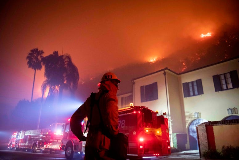 A firefighter watches a flames approach the Mandeville Canyon neighborhood during the Getty fire, Monday, Oct. 28, 2019, in Los Angeles, Calif. California wildfires
