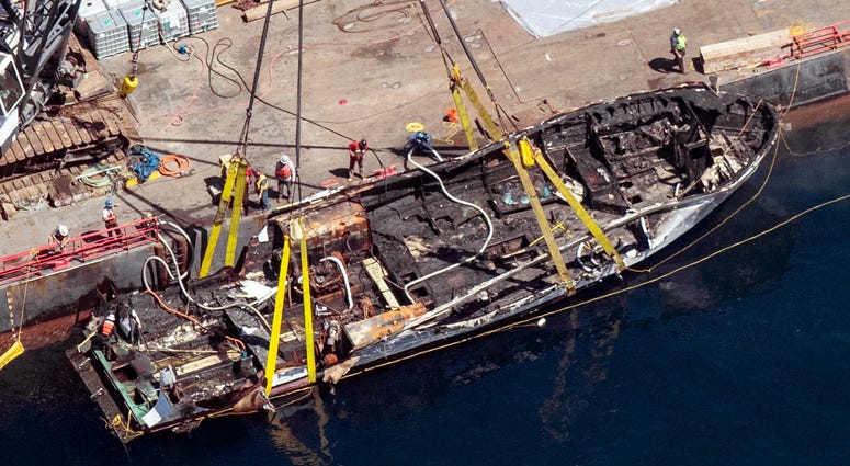 In this Sept. 12, 2019, file photo, the burned hull of the dive boat Conception is brought to the surface by a salvage team off Santa Cruz Island, Calif. Boat fire in California